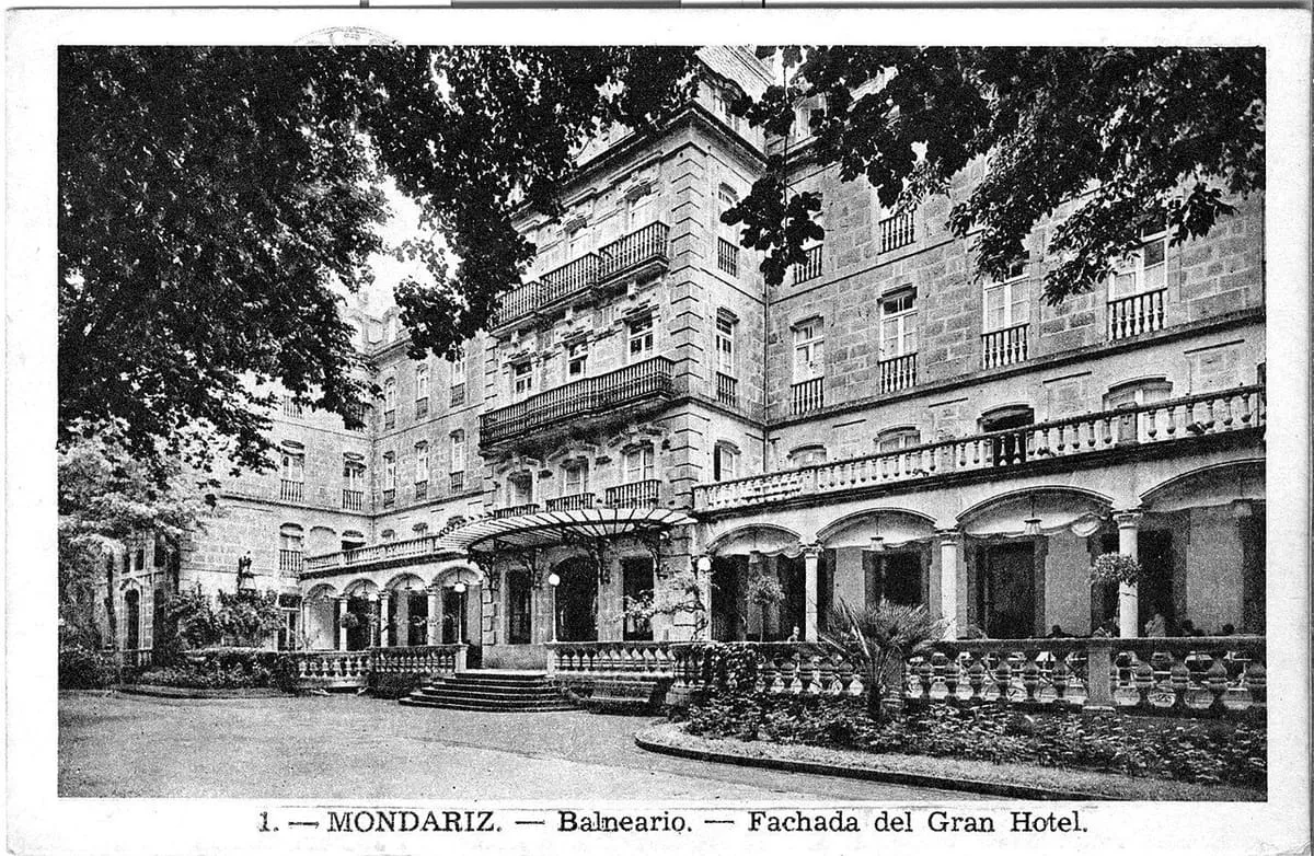 Fotografía antigua en blanco y negro de la fachada del Gran Hotel, con sus arcadas y una balconada