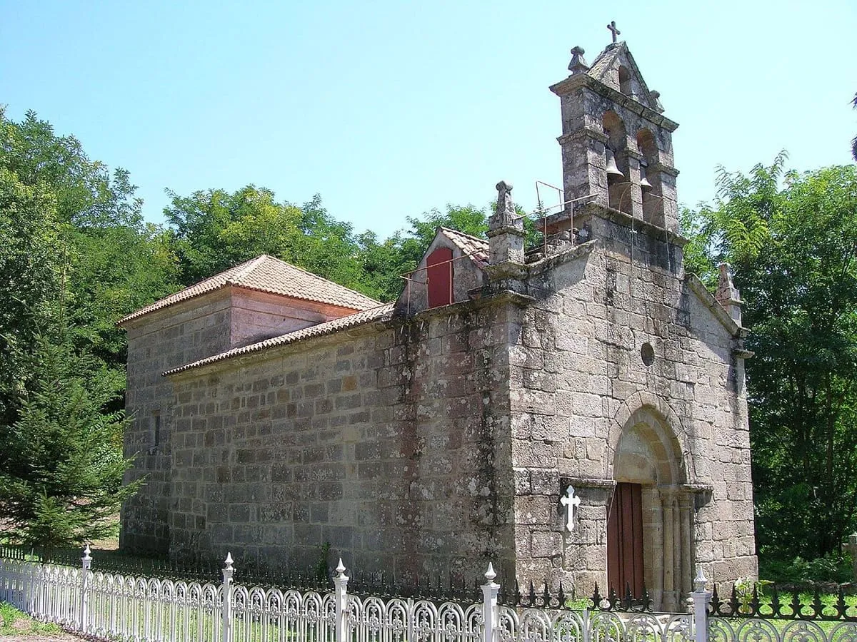 La iglesia de Santo Estevo de Cumiar, de piedra, con espadaña y un cerramiento blanco