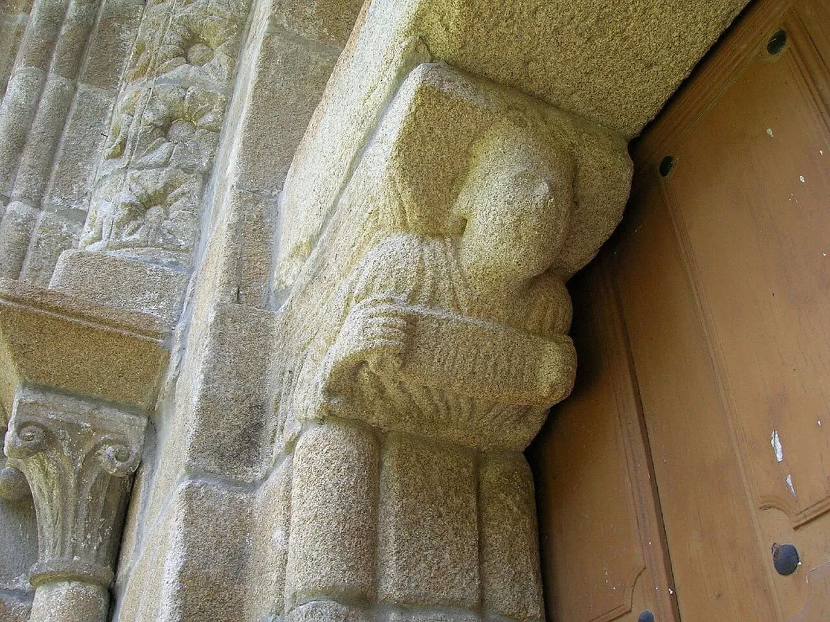 Una mocheta con una figura esculpida junto a la puerta de San Salvador de Padróns