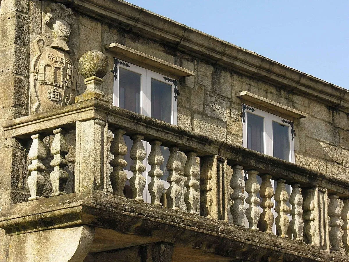 Balconada del pazo de Martelo con el escudo de armas tallado en la esquina