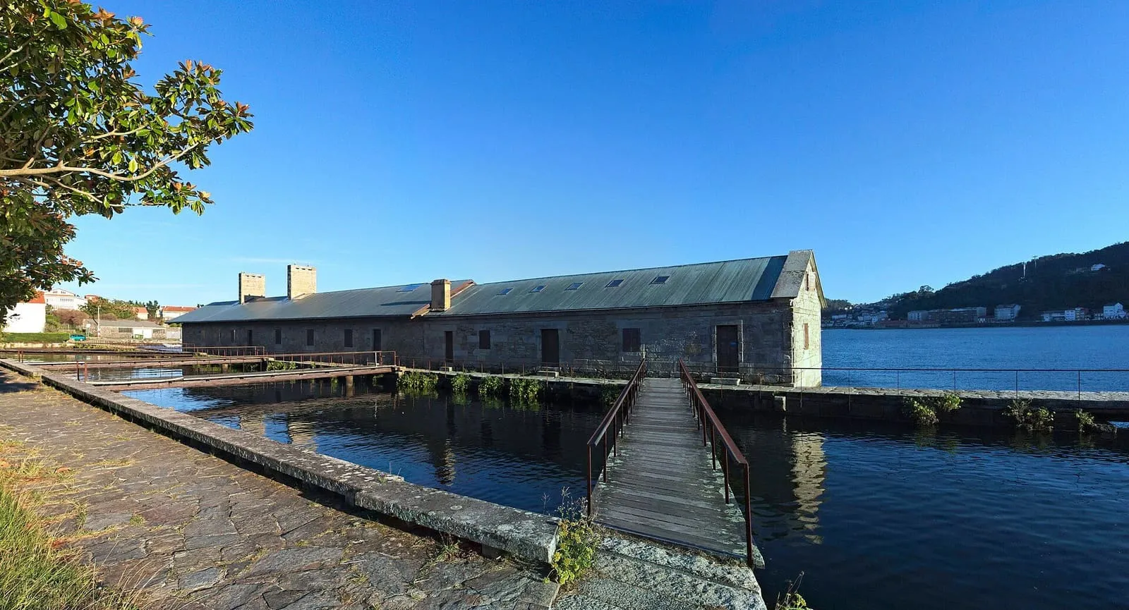 El gran molino de mareas del Pozo do Cachón con su pasarela de madera sobre la ría